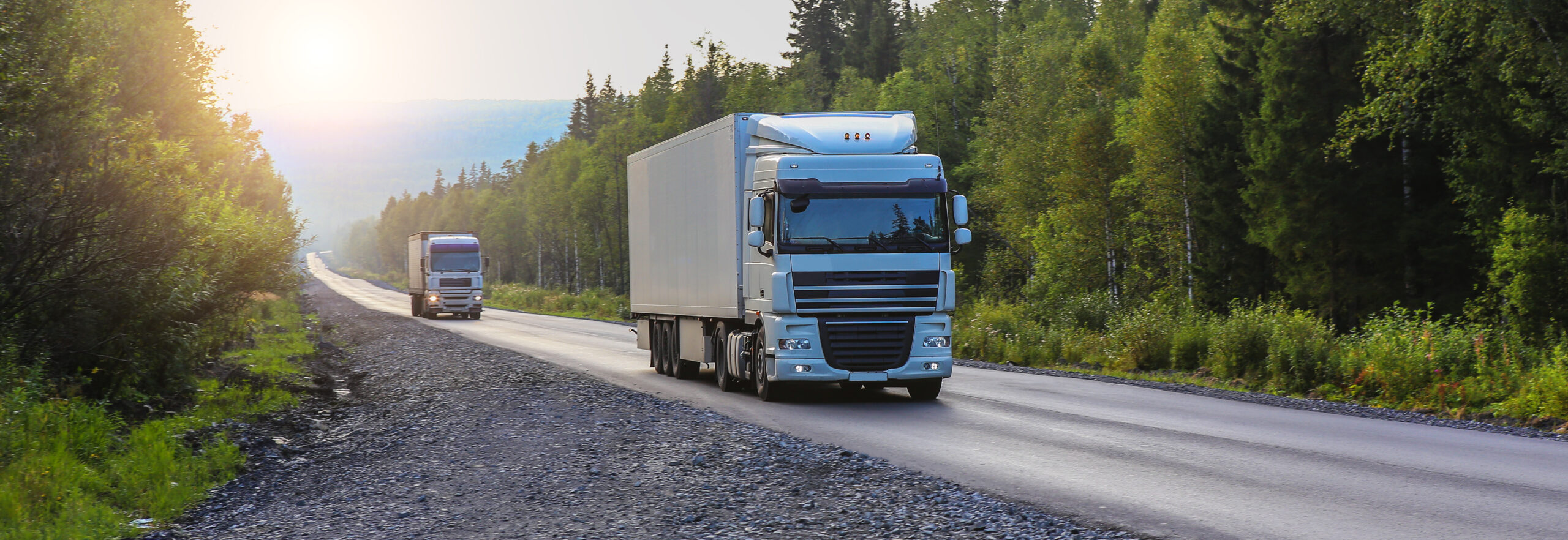 Trucks move on a country road